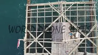 Drone moving forward vertical shot of Java fishing structure, Carita, Java, Sunda Strait, Indonesia