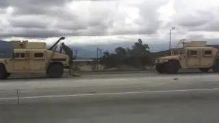 Military trucks on the CA-215 Fwy