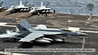 US sailors conduct operations in the hangar of the Nimitz class aircraft carrier, USS Nimitz