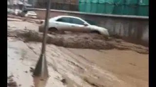 Floodwater Washes away Cars in Southwest China