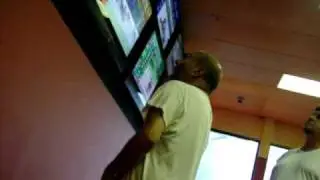 Crazy George yelling for horse in Off Track Betting (OTB)