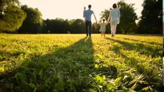 Happy family with two children walking in the sun
