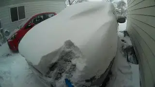 Brushing Snow Off Car After 3-day Snowstorm