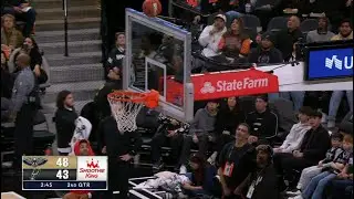 A Spurs fan makes the halfcourt shot off the shot clock to win $10,000!