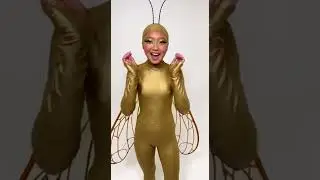 A teenager girl wears a gold cicada lycra spandex costume