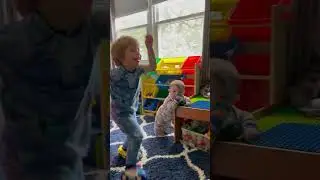 Liam dances the Cha Cha Slide while Carmine chews on toys
