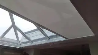 SHY ZIP rooflight blind with battery and solar panel fitted to conservatory
