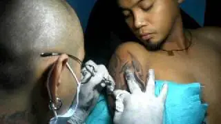 getting a custom black and gray tattoo in morbid tattoo shop