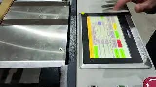 Cardboard corner cutting machine for removing the corners before V grooving