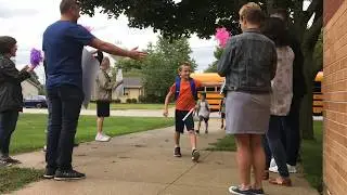 Community members welcome back students at Clarendon Avenue Elementary