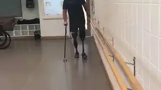 An Amputee Man Wearing Prosthetic Legs Fell Down While Practicing To Walk.
