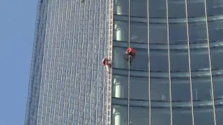 French urban climbers scale building in Frankfurt to raise awareness about climate change | AFP