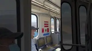 Los Angeles Metro C (formerly called Green) line running down the Imperial Fwy median, passing cars