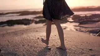 Girl walking in barefoot in the beach sand