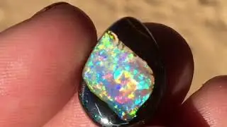 A Koroit opal cab cut from a nut