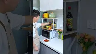 Placing a multi-tiered rack like this on top of your microwave or oven not only saves counter space