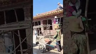 Lifting process of red tiles on villa roof