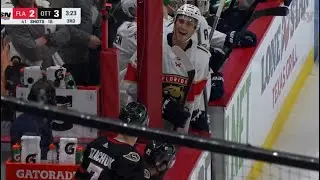 Brady Tkachuk and Mason Marchment exchanging chirps at the bench