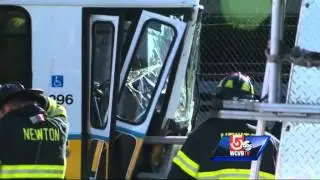 MBTA bus crashes through guardrail, hangs over Mass Pike