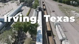 Train Departing Downtown Irving Station with Cityscape in Background