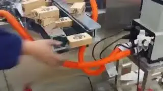 Cartoning machine for tissue feeding by manual on conveyor