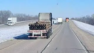 This guy has a dangerous rig! Missing tire and loose steel load waiting to cause a wreck!