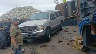 Looking at a small mining dredge while lifting the suv off the vessel 