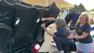 Paul Duetschman Signing the Hood of Bev's 1993 Callaway SuperNatural Aerobody Corvette