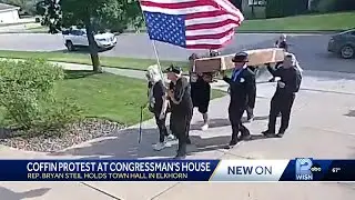 Protesters carry cardboard coffin to US Rep. Bryan Steil's home