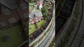 57007 pulling coal past the village. Freightliner DCC with Sound.