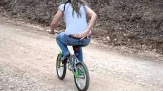 Girl riding bike in high heels