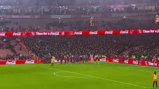Manchester United fans celebrating at the Emirates after beating Arsenal