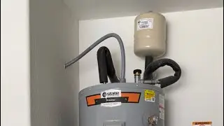 Replacing an anode rod on a water heater that was causing a sulfur smell.