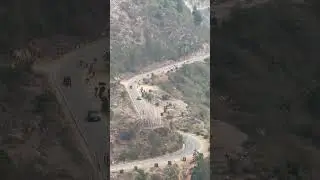 A bustling road filled with marching horses, a speeding tractor, and hurried cars. #bhutan #nature