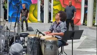 Conga player warms up.