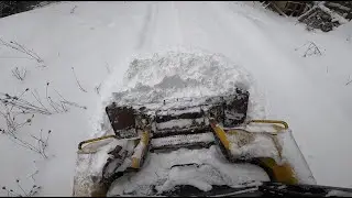Beginner skid steer operator on icy driveway