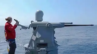 US Navy Female Shows Skill Holding a Mk-38 25mm Chain Gun During Live Fire Exercise