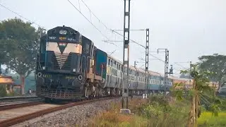 Aggressive speedy diesel express trains tilting on a huge curve