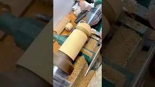Skilled Wood Turning on a Lathe to Create Intricate Cylindrical Shapes