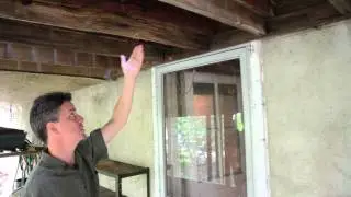 A disater waiting to happen! A deck with a glass structure on top near collapse DeckRemodelers.com