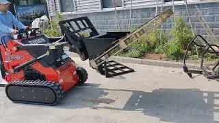 TYPHON STOMP Skid-Steer Loader with forklift pallet attachment