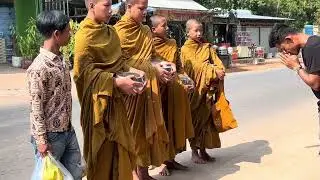 Buddhism Monks walking for collecting alms & blessings for local communities in compassion & peace 