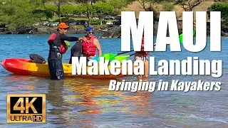 Instructor brings in kayak with two passengers in gentle surf at Makena Landing, Maui, Hawaii 4K