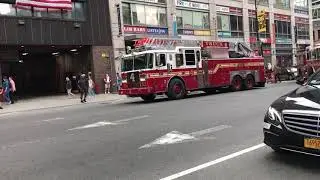 FDNY LADDER 4 & ENGINE 54 RETURNING TO QUARTERS ON 8TH AVENUE IN MIDTOWN, MANHATTAN, NEW YORK CITY.