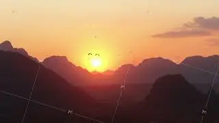 Hot air balloon flying over mountains at sunrise in Laos for an outdoor adventure tourism experience