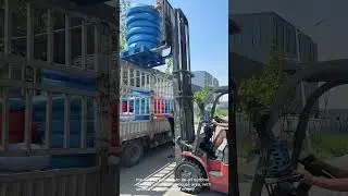 Forklift in Action: Plastic Bucket Loading for Distribution
