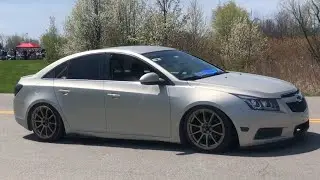 Modded Chevy Cruze And V6 Mustang Leaving A Car Show