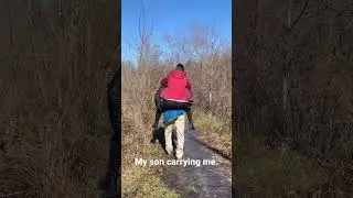 My son carrying me over a slippery trail.