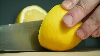 Cutting lemon in two halves in slow motion. Free HD video footage