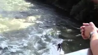 Surfer practices on River Graz Austria attached by rope to